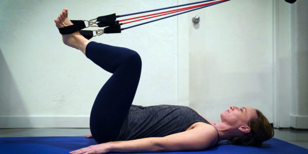 Amy Kingwill Pilates Feet in straps frog at home